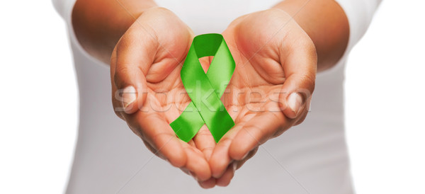 hands holding green awareness ribbon Stock photo © dolgachov