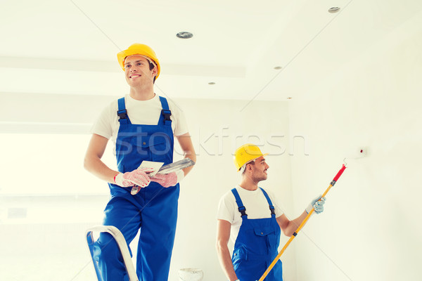 group of builders with tools indoors Stock photo © dolgachov