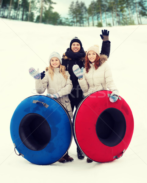 group of smiling friends with snow tubes Stock photo © dolgachov