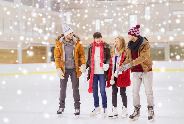 Stock photo: happy friends on skating rink
