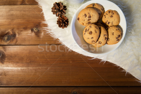 close up of cookies in bowl and cones on fur rug Stock photo © dolgachov