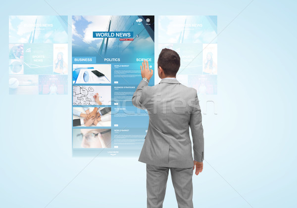 man with virtual projection of business news Stock photo © dolgachov