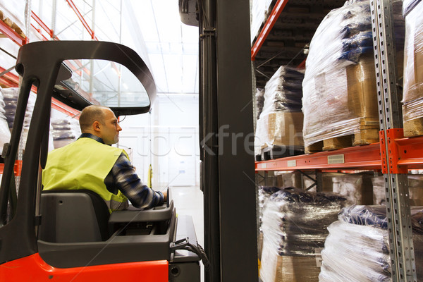 man operating forklift loader at warehouse Stock photo © dolgachov