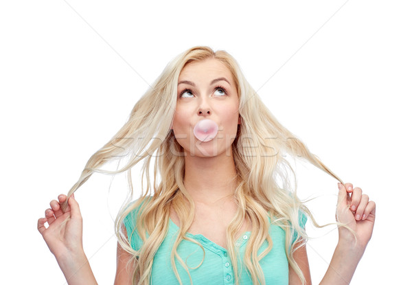 happy young woman or teenage girl chewing gum Stock photo © dolgachov