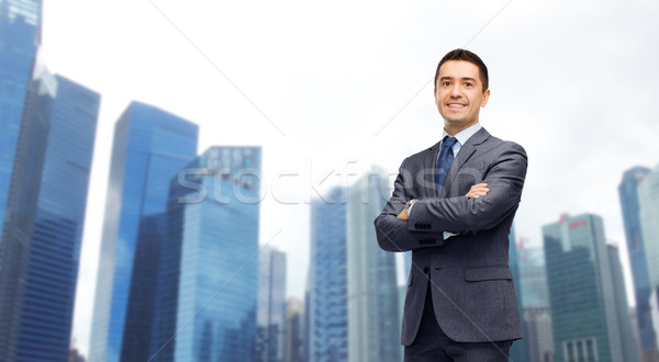 happy smiling businessman over singapore city  Stock photo © dolgachov