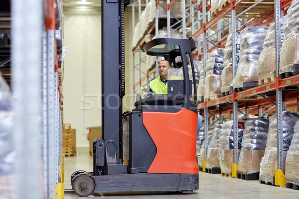 man operating forklift loader at warehouse Stock photo © dolgachov