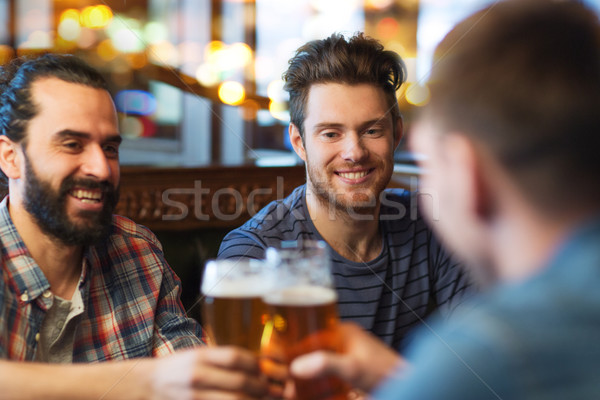 happy male friends drinking beer at bar or pub Stock photo © dolgachov