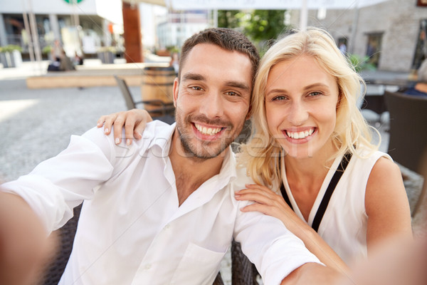 happy couple taking selfie at restaurant terrace Stock photo © dolgachov