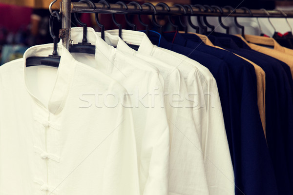 male shirts on hanger at asian street market Stock photo © dolgachov