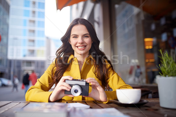 Stock photo: happy tourist woman with camera at city cafe