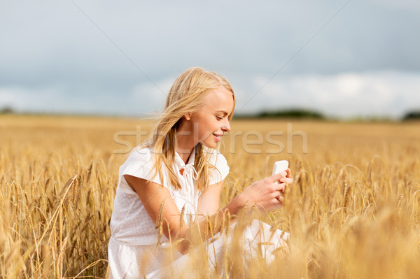 happy woman with smartphone and earphones Stock photo © dolgachov