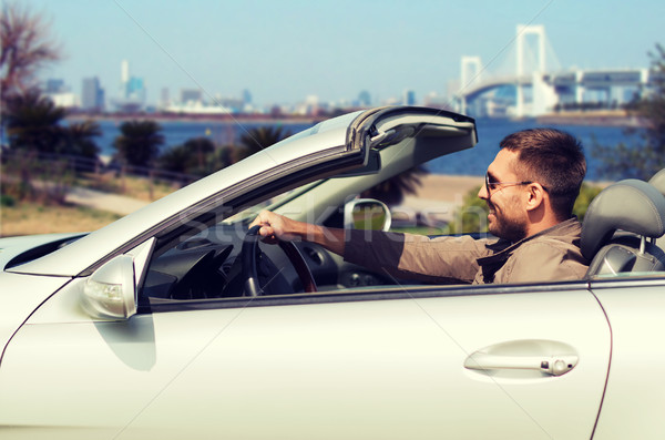 happy man driving cabriolet car in tokyo Stock photo © dolgachov