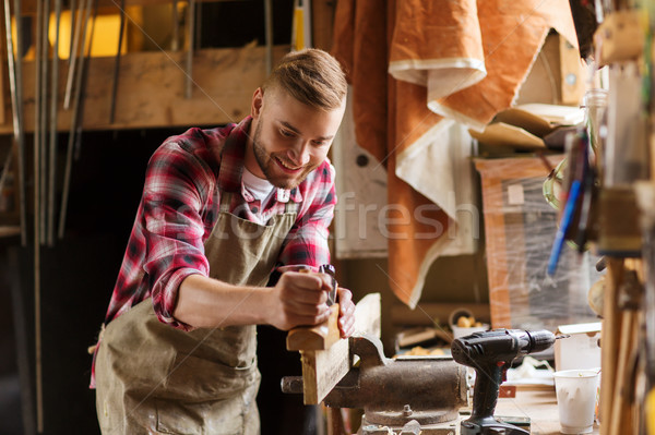 Stock photo: carpenter working with plane and wood at workshop