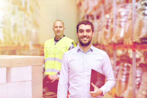 businessman with clipboard  over warehouse loader Stock photo © dolgachov