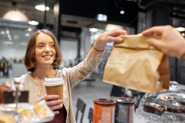 woman taking paper bag from seller at cafe Stock photo © dolgachov