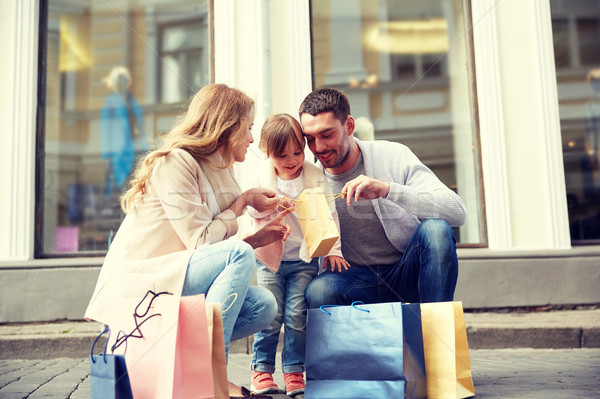 happy family with child and shopping bags in city Stock photo © dolgachov