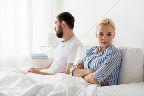 Stock photo: unhappy couple having conflict in bed at home