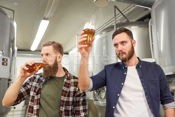 men testing non-alcoholic craft beer at brewery Stock photo © dolgachov