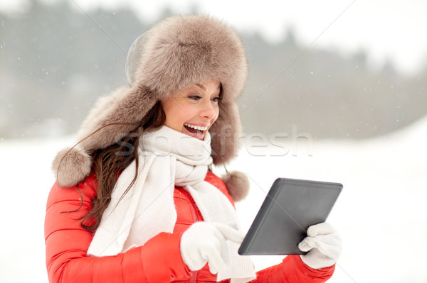 Stock photo: woman in winter fur hat with tablet pc outdoors