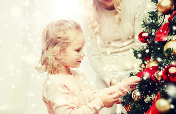 happy family decorating christmas tree at home Stock photo © dolgachov