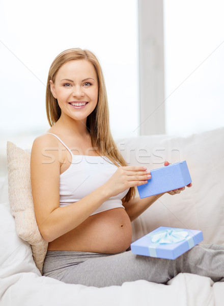 smiling pregnant woman opening gift box Stock photo © dolgachov