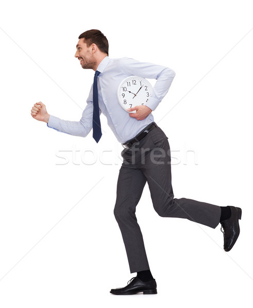 smiling young businessman with clock running Stock photo © dolgachov