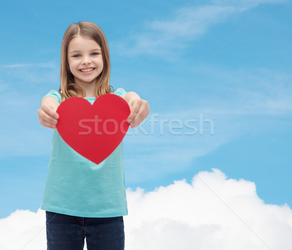 Stock photo: smiling little girl giving red heart