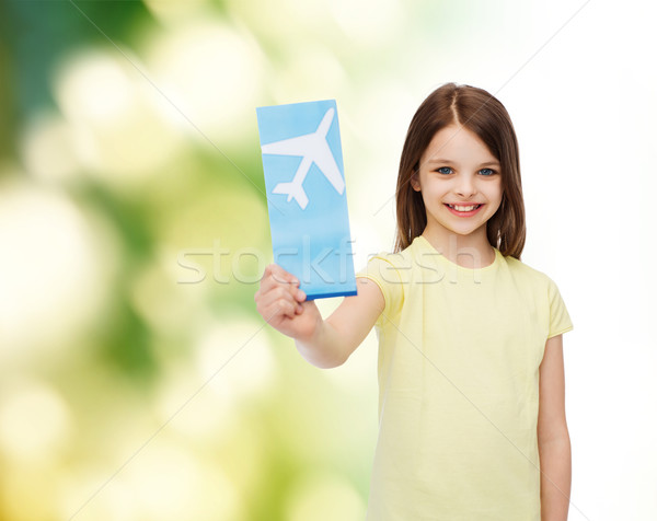 smiling little girl with airplane ticket Stock photo © dolgachov