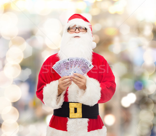 Adam kostüm noel baba euro para Noel Stok fotoğraf © dolgachov