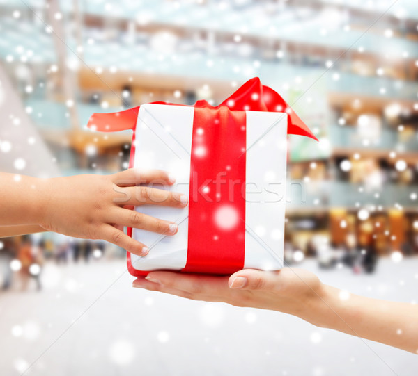 close up of child and mother hands with gift box Stock photo © dolgachov