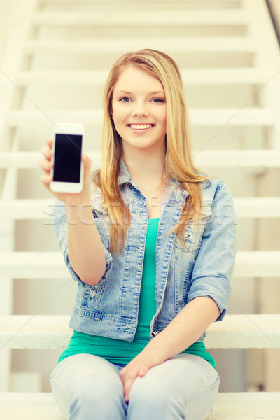 smiling student with smartphone blank screen Stock photo © dolgachov