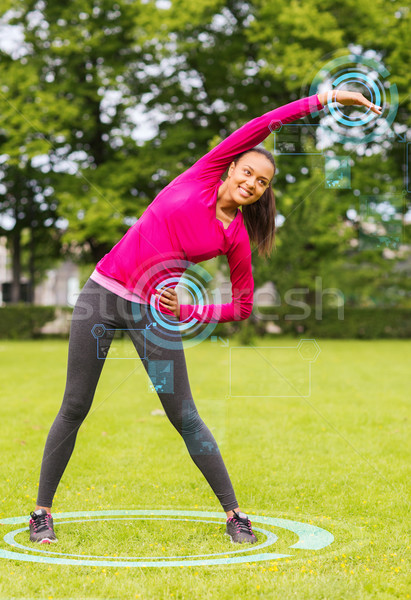 smiling woman stretching back outdoors Stock photo © dolgachov