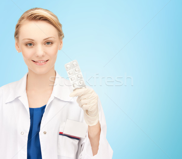 happy female doctor with pills Stock photo © dolgachov