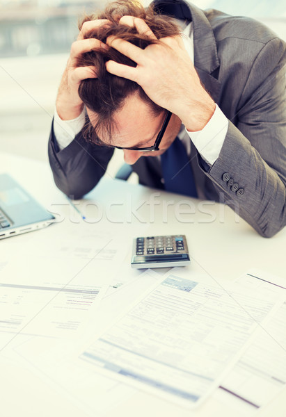 businessman with papres, laptop and calculator Stock photo © dolgachov