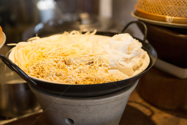 bowl of rice noodles garnish at asian restaurant Stock photo © dolgachov