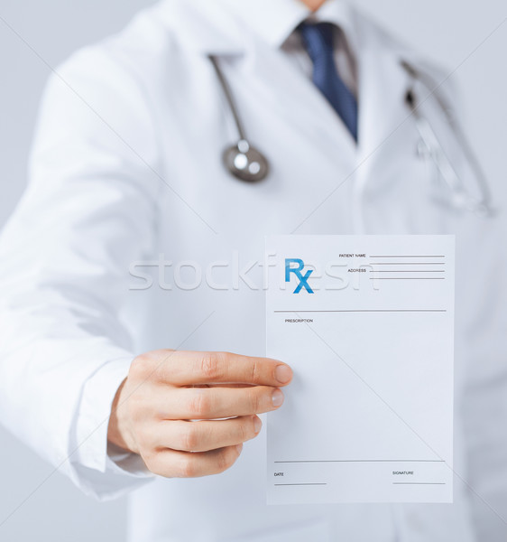 male doctor holding rx paper in hand Stock photo © dolgachov
