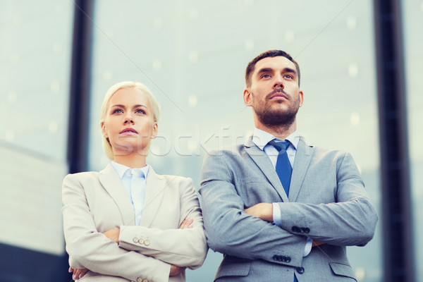 serious businessmen standing over office building Stock photo © dolgachov