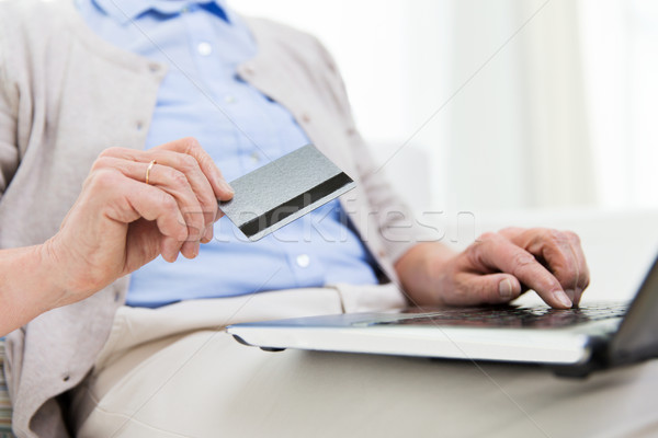 senior woman with laptop and credit card at home Stock photo © dolgachov