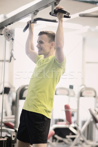 smiling man exercising in gym Stock photo © dolgachov