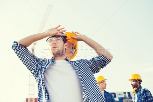 Stock photo: group of builders in hardhats outdoors