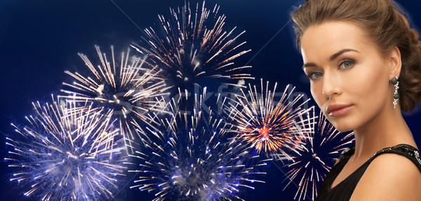 beautiful woman wearing earrings over firework Stock photo © dolgachov