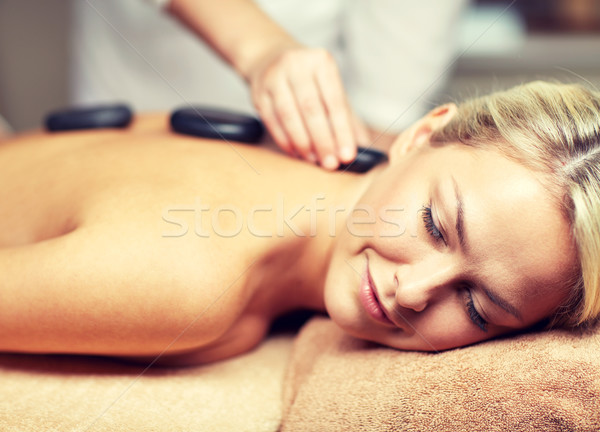 close up of woman having hot stone massage in spa Stock photo © dolgachov