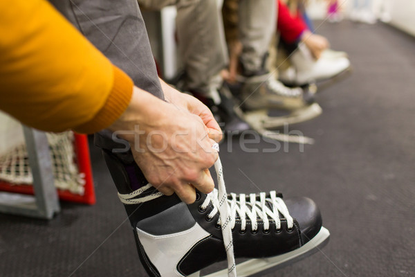 close up of friends wearing skates on skating rink Stock photo © dolgachov