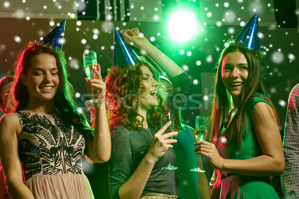 smiling friends with glasses of champagne in club Stock photo © dolgachov