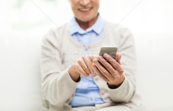 close up of senior woman with smartphone texting Stock photo © dolgachov