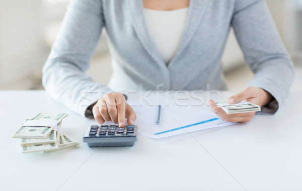 close up of hands counting money with calculator Stock photo © dolgachov