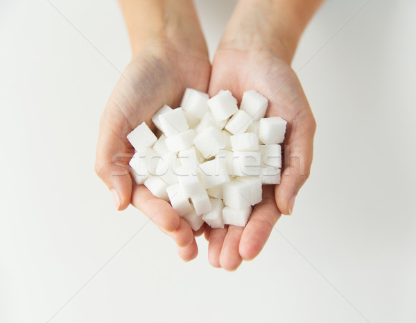 close up of white lump sugar in woman hands Stock photo © dolgachov