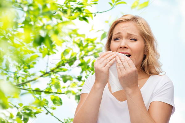 unhappy woman with paper napkin sneezing Stock photo © dolgachov