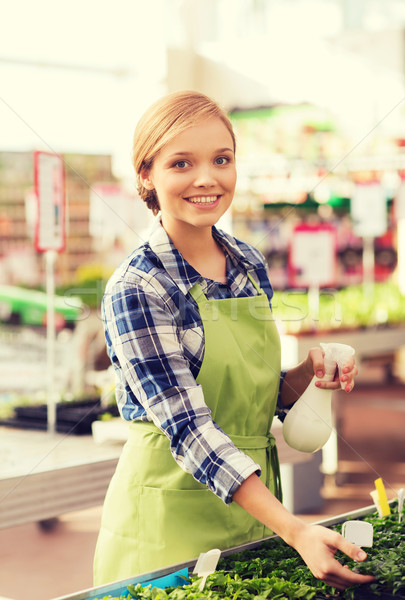 woman with sprayer and seedling in greenhouse Stock photo © dolgachov