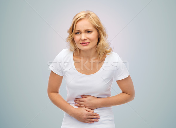 unhappy woman suffering from stomach ache Stock photo © dolgachov